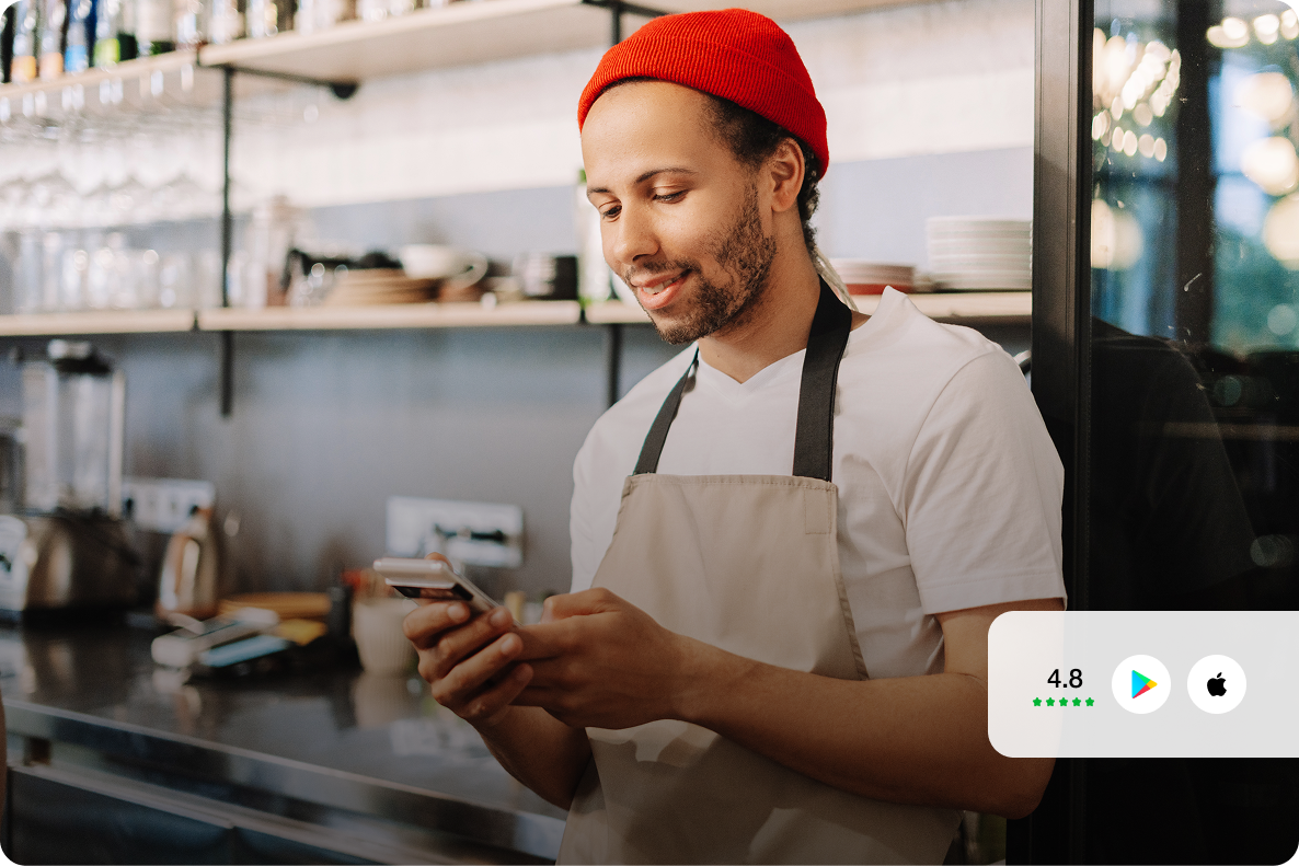 Barista using the mobile app with mobile feature badges